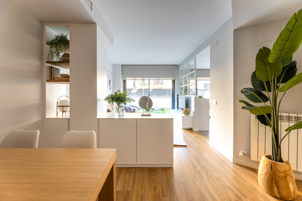 Imagen de comedor nórdico de tamaño medio abierto con paredes grises, suelo de madera en tonos medios y suelo marrón