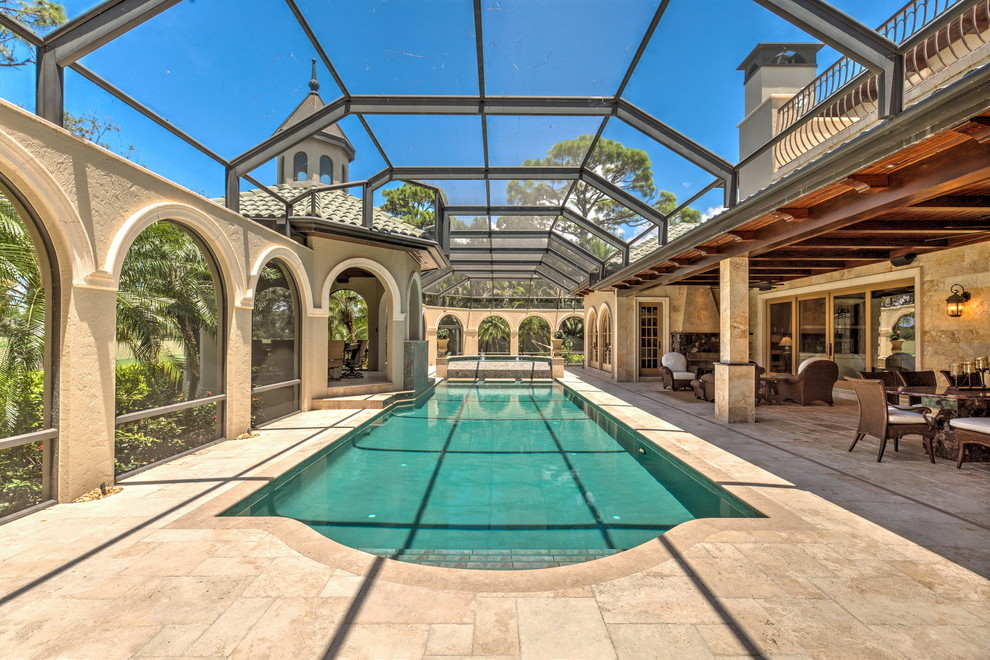 Mediterranean indoor pool in Tampa with a pool house.