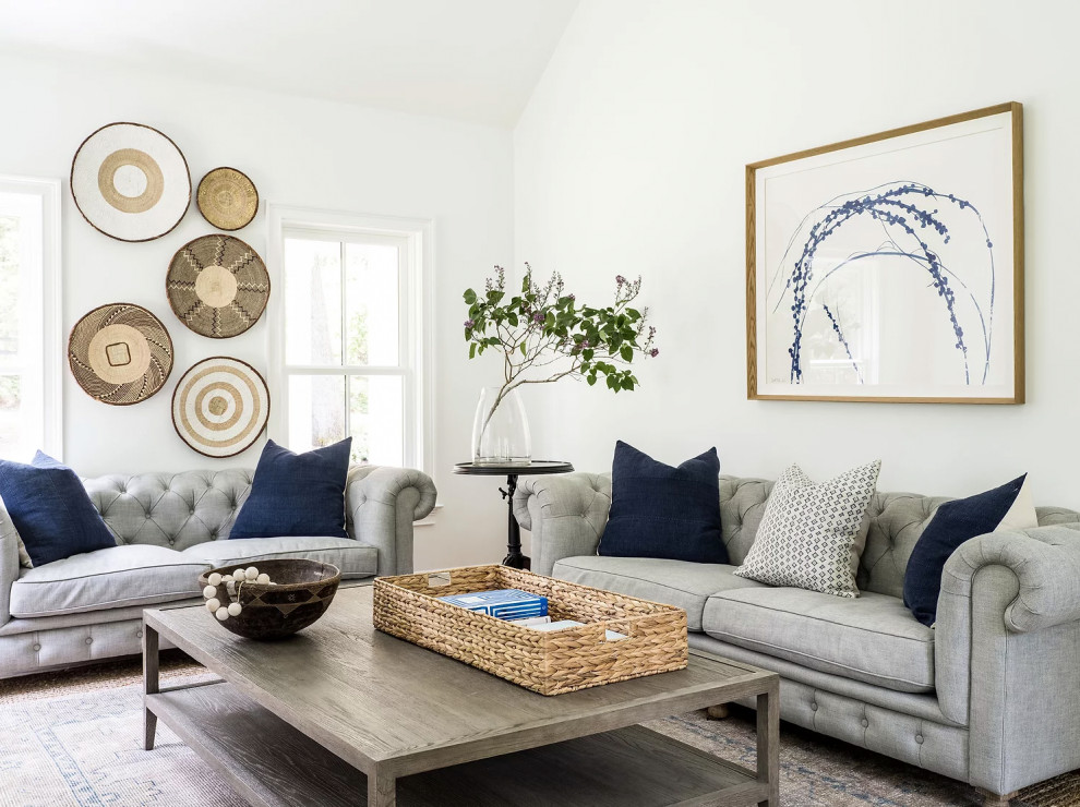 This is an example of a transitional living room in Boston with white walls and vaulted.