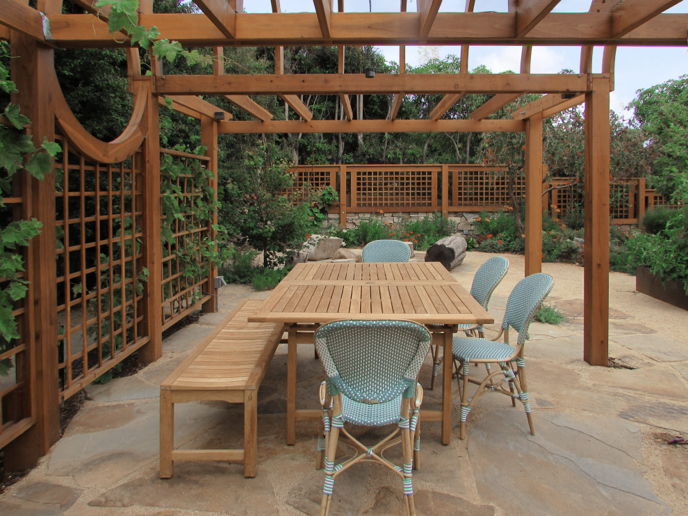 Design ideas for a mid-sized mediterranean backyard patio with a fire feature and natural stone pavers.