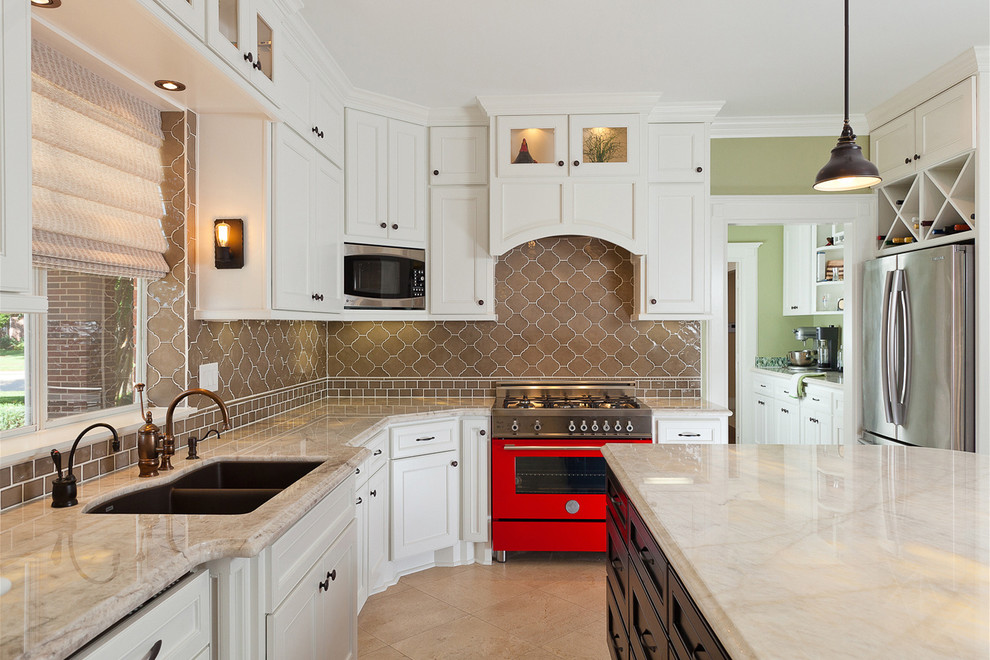 This is an example of a traditional kitchen in Houston with a double-bowl sink, recessed-panel cabinets, white cabinets, marble benchtops, brown splashback, coloured appliances and beige benchtop.