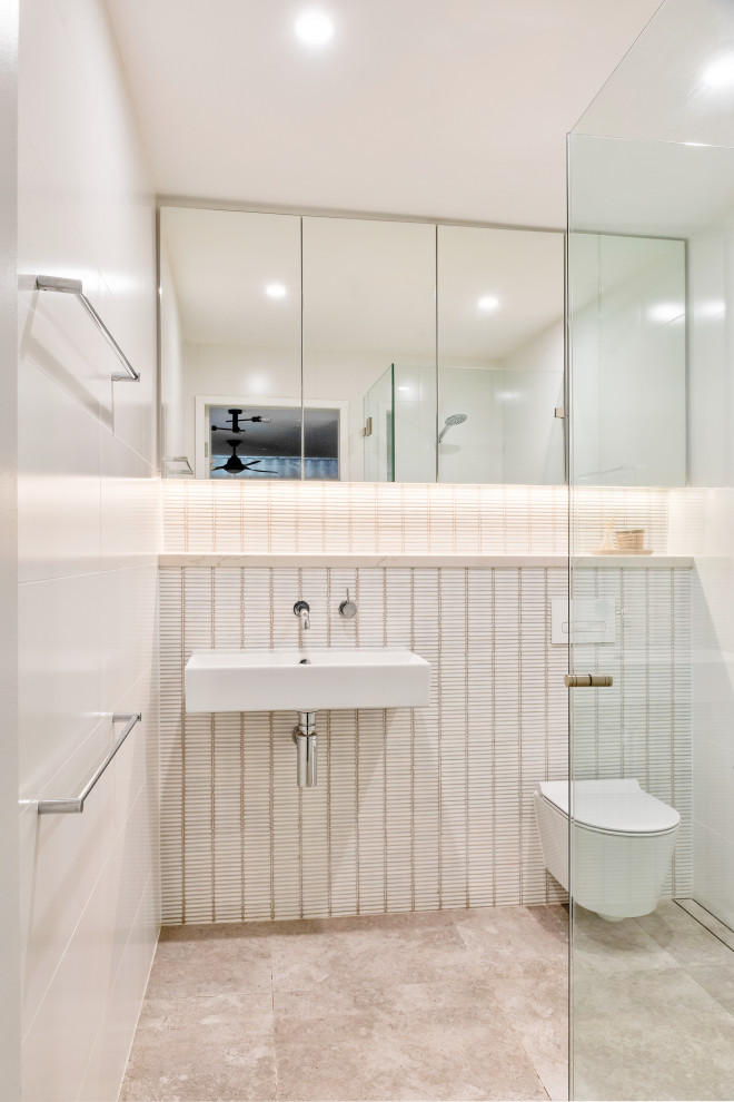 Inspiration for a contemporary bathroom in Sydney with a corner shower, white tile, mosaic tile, a wall-mount sink, grey floor and a single vanity.