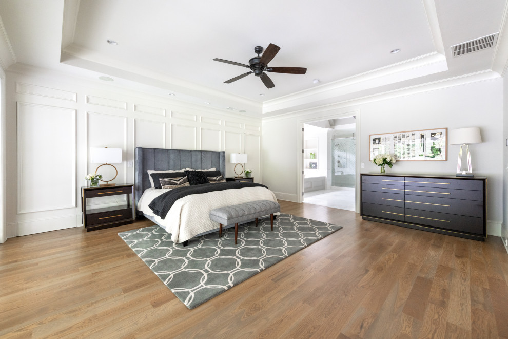 Design ideas for a contemporary bedroom in Atlanta with white walls and light hardwood flooring.