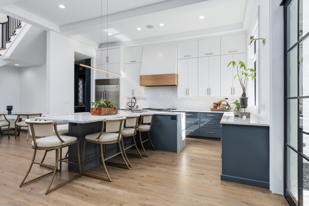 This is an example of a large contemporary l-shaped kitchen/diner in Other with a submerged sink, flat-panel cabinets, engineered stone countertops, white splashback, porcelain splashback, stainless steel appliances, light hardwood flooring, an island, white worktops and exposed beams.