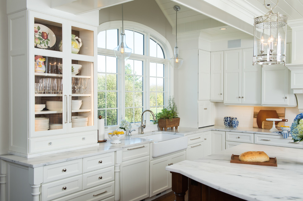 Design ideas for a large transitional u-shaped open plan kitchen in Chicago with a farmhouse sink, shaker cabinets, white cabinets, marble benchtops, white splashback, subway tile splashback, panelled appliances, dark hardwood floors, with island and white benchtop.