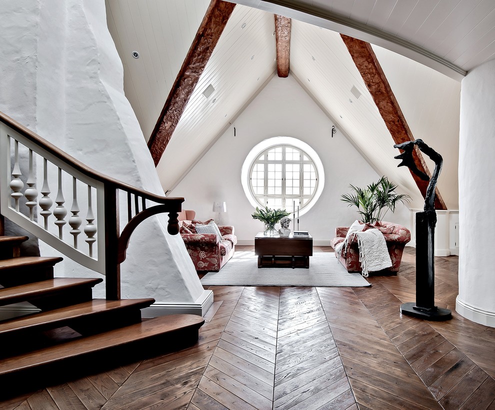 This is an example of an expansive country loft-style family room in Gothenburg with white walls, dark hardwood floors and brown floor.