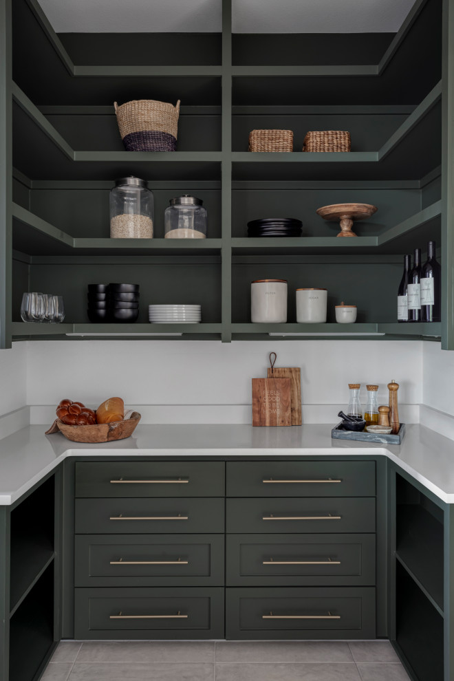 Photo of a medium sized rural u-shaped kitchen pantry in Austin with a belfast sink, shaker cabinets, green cabinets, engineered stone countertops, white splashback, engineered quartz splashback, stainless steel appliances, light hardwood flooring, an island, brown floors, white worktops and a timber clad ceiling.