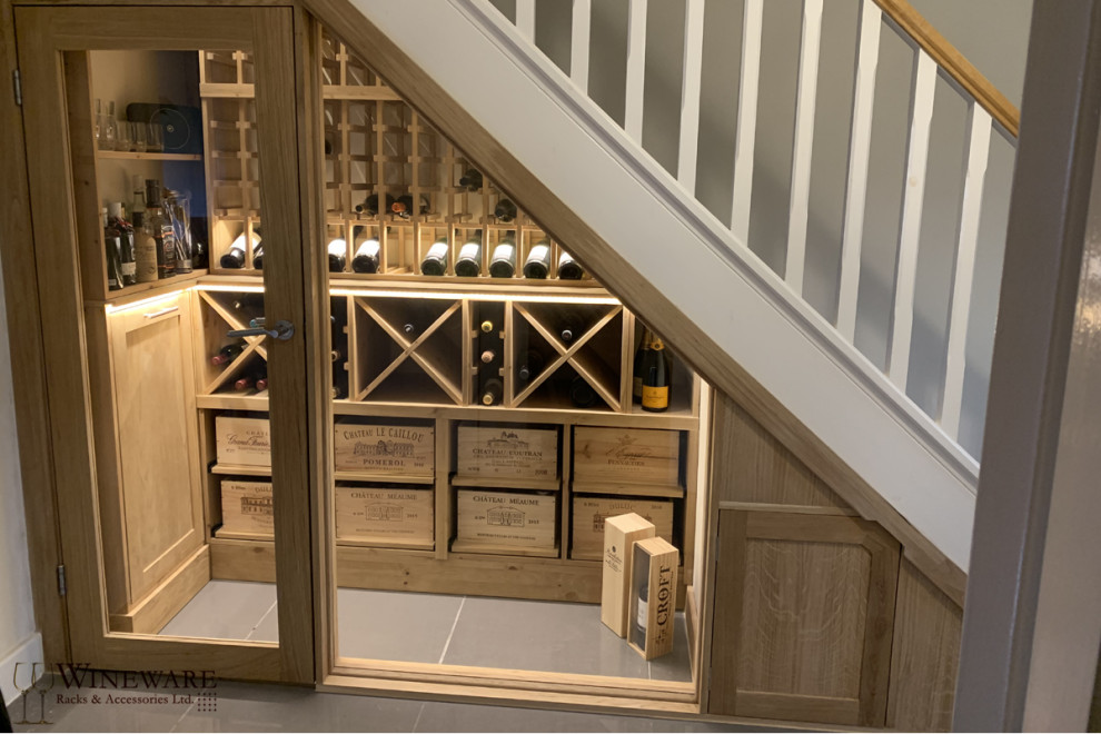 Mid-sized contemporary wine cellar in Oxfordshire with grey floor.