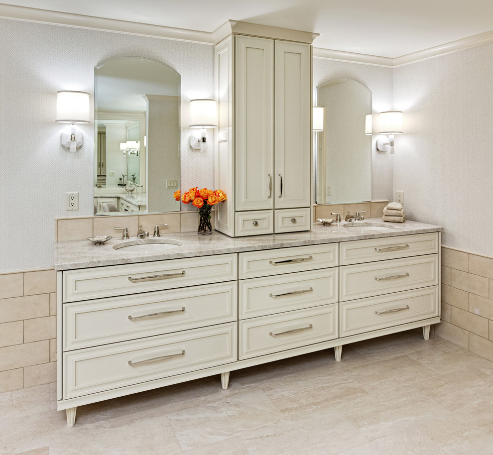 Inspiration for a mid-sized transitional master bathroom in Minneapolis with recessed-panel cabinets, white cabinets, a freestanding tub, brown tile, stone tile, grey walls, marble floors, an undermount sink, granite benchtops, beige floor, a hinged shower door and grey benchtops.