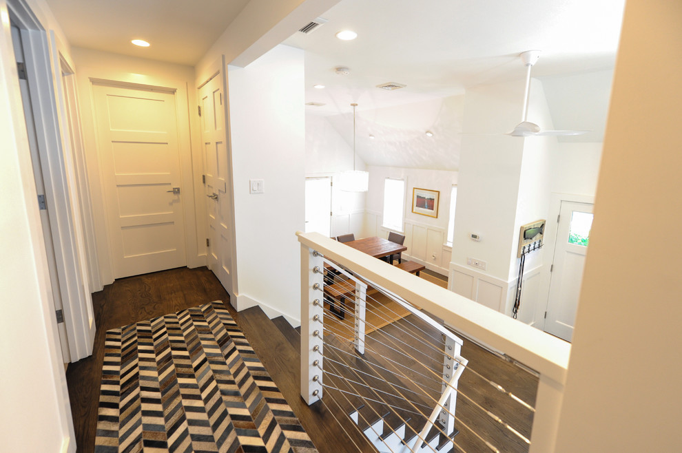 Inspiration for a mid-sized modern hallway in Boston with white walls and dark hardwood floors.
