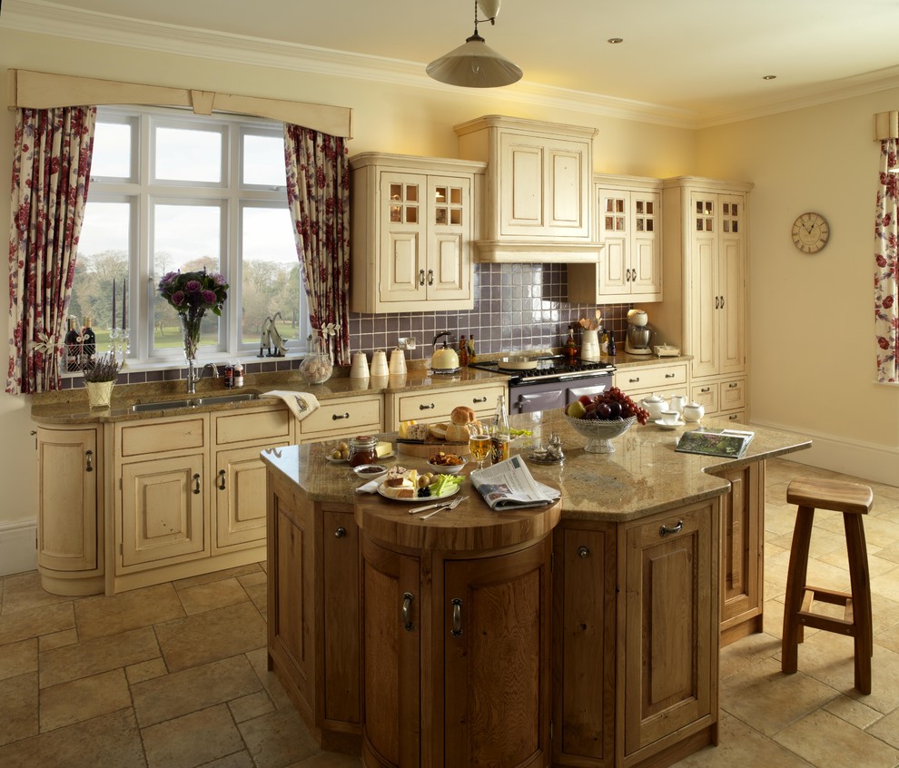 Inspiration for a traditional kitchen in London with raised-panel cabinets.