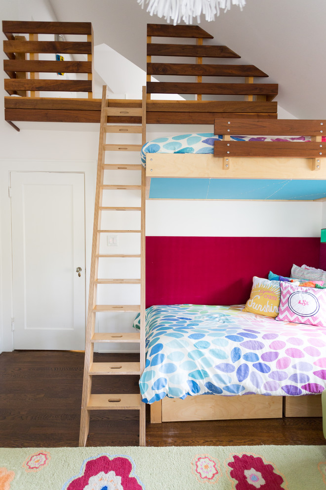 Photo of a mid-sized contemporary kids' room for girls in Kansas City with white walls and dark hardwood floors.