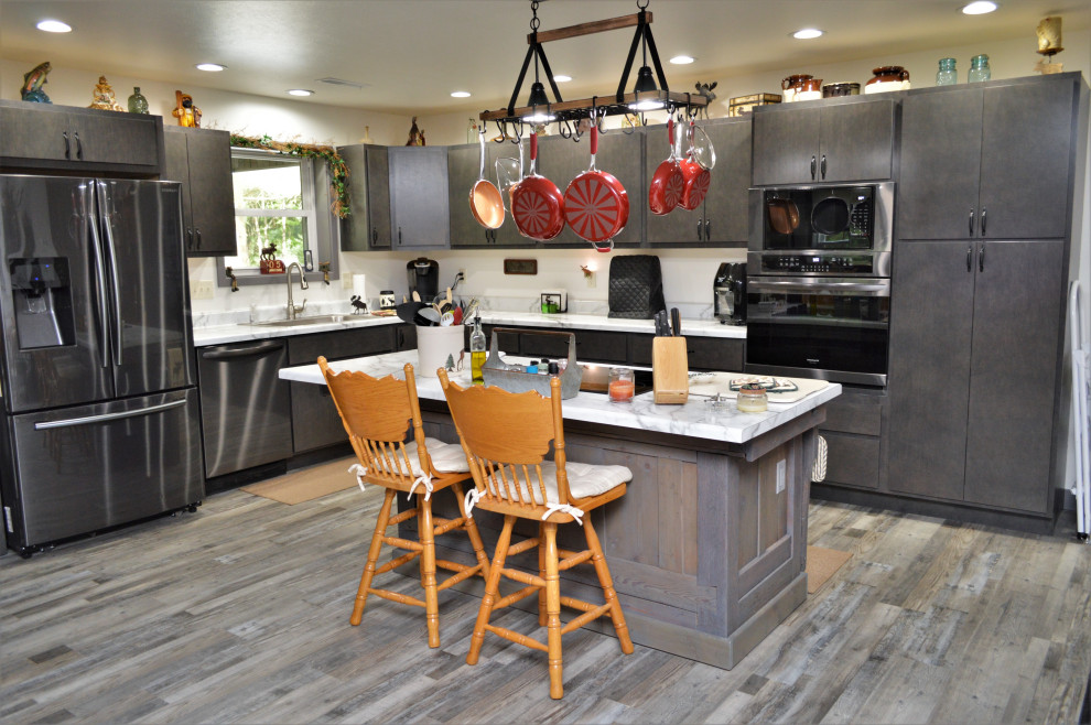 Design ideas for a mid-sized contemporary l-shaped open plan kitchen in Other with a drop-in sink, flat-panel cabinets, grey cabinets, laminate benchtops, laminate floors, with island, grey floor and yellow benchtop.