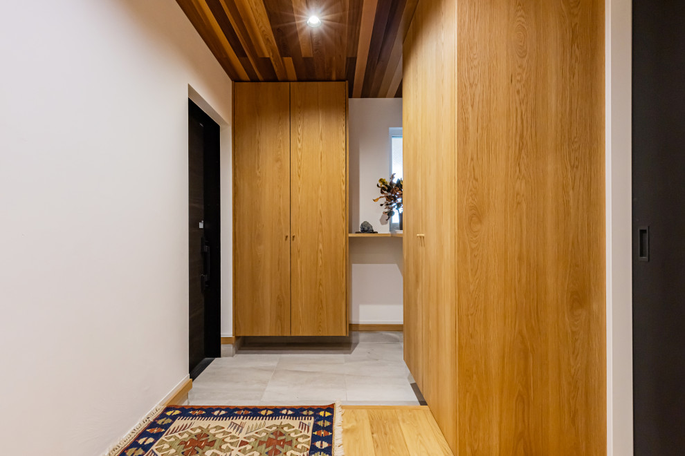 Idée de décoration pour une entrée minimaliste de taille moyenne avec un couloir, une porte simple et un plafond en bois.