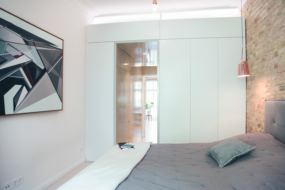 This is an example of a large contemporary bedroom in Berlin with green walls, carpet and beige floor.