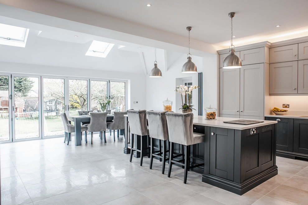 Traditional open plan kitchen in Other with a double-bowl sink, shaker cabinets, blue cabinets, quartzite benchtops, white splashback, stainless steel appliances, ceramic floors, with island, grey floor and white benchtop.
