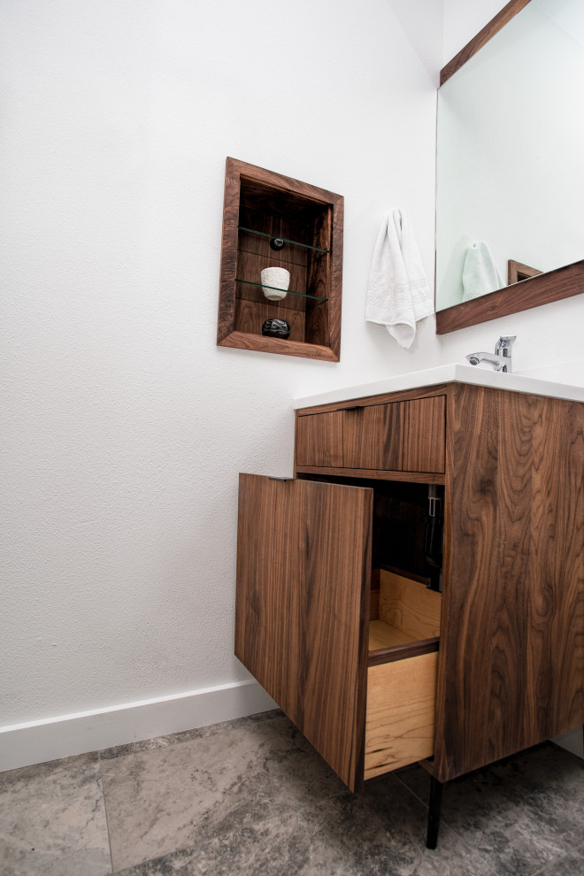 Photo of a mid-sized modern 3/4 bathroom in Portland with flat-panel cabinets, dark wood cabinets, a double shower, a two-piece toilet, brown tile, ceramic tile, white walls, ceramic floors, an undermount sink, engineered quartz benchtops, grey floor, a hinged shower door and white benchtops.