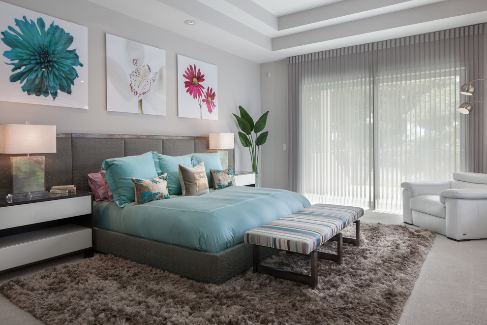 Photo of a contemporary master bedroom in Miami with grey walls and carpet.