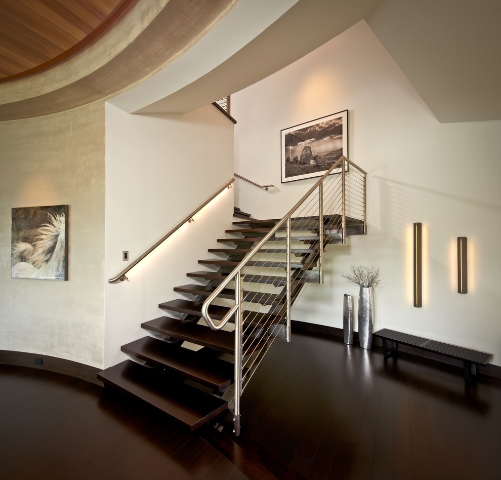 Trendy wooden l-shaped dark wood floor, open and cable railing staircase photo in Houston with white walls