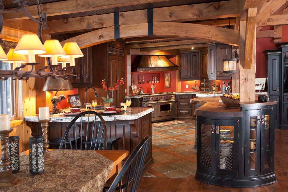 Eat-in kitchen - mid-sized rustic u-shaped medium tone wood floor eat-in kitchen idea in Toronto with raised-panel cabinets, distressed cabinets, granite countertops, paneled appliances and an island