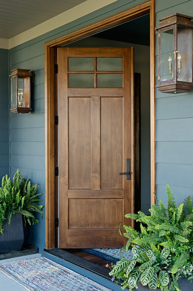 Photo of a mid-sized traditional front door in Nashville with a medium wood front door, blue walls and a double front door.