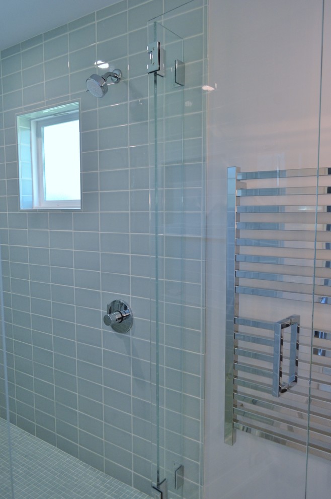 This is an example of a mid-sized transitional 3/4 bathroom in San Francisco with flat-panel cabinets, medium wood cabinets, a double shower, blue tile, glass tile, concrete floors, an undermount sink, granite benchtops, green floor, a hinged shower door and multi-coloured benchtops.