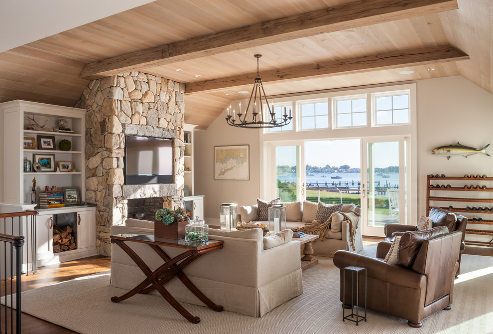 This is an example of a beach style family room in Bridgeport with bamboo floors, a standard fireplace and a stone fireplace surround.