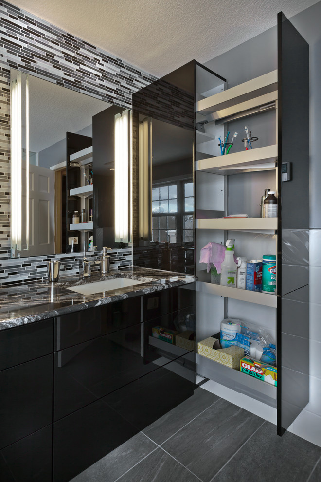 Mid-sized contemporary master bathroom in Minneapolis with an undermount sink, flat-panel cabinets, black cabinets, granite benchtops, a curbless shower, a two-piece toilet, glass tile, grey walls, porcelain floors and black and white tile.