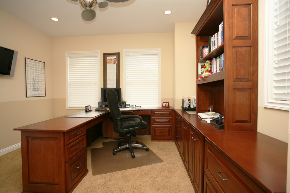 Photo of a mid-sized traditional study room in Orange County with beige walls, carpet and a built-in desk.