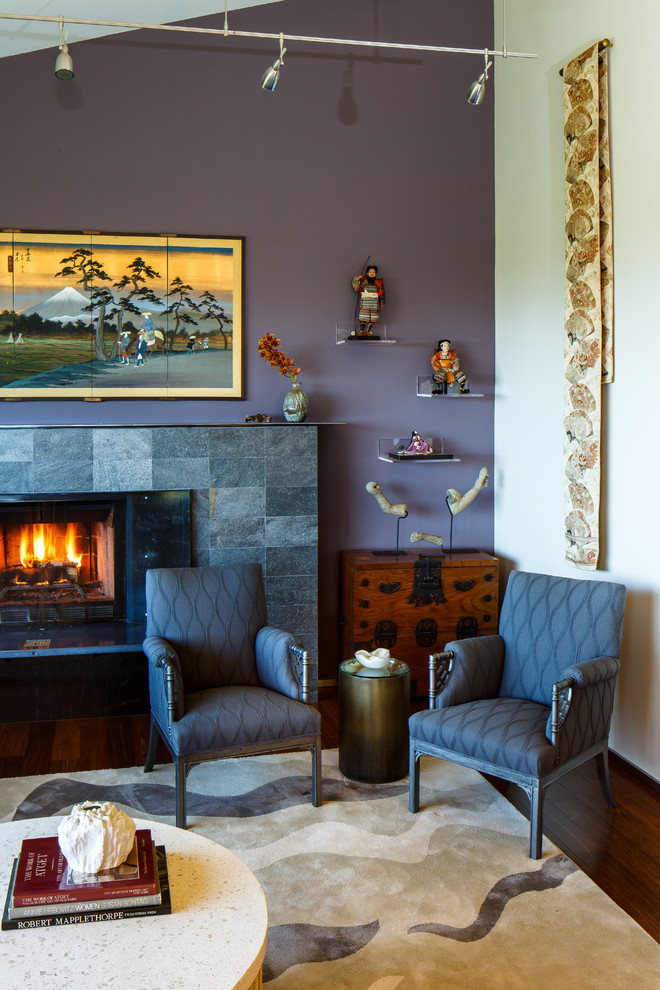 This is an example of a mid-sized asian formal open concept living room in San Francisco with purple walls, a standard fireplace, a stone fireplace surround, no tv and dark hardwood floors.