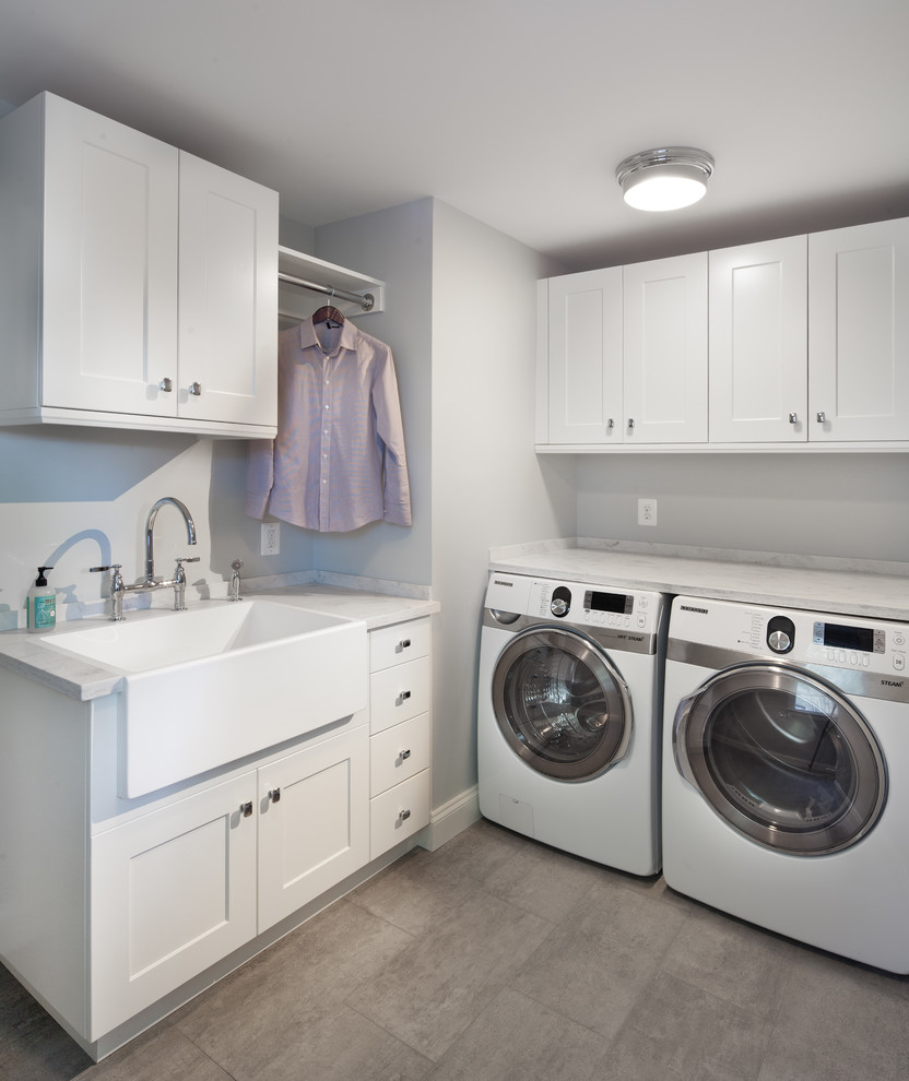 Design ideas for a transitional laundry room in DC Metro with a farmhouse sink, white cabinets and white benchtop.