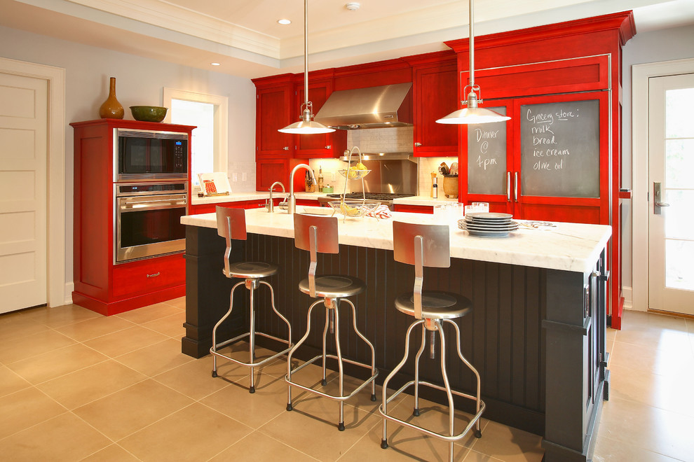Mid-sized eclectic l-shaped kitchen in New York with stainless steel appliances, red cabinets, an undermount sink, shaker cabinets, marble benchtops, ceramic floors, with island, grey splashback, subway tile splashback and brown floor.