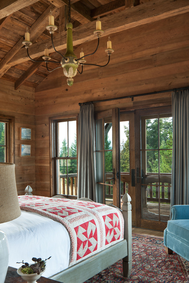 Example of a mid-sized mountain style master medium tone wood floor and brown floor bedroom design with brown walls