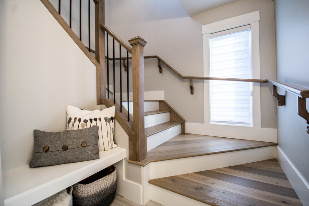 Staircase - mid-sized transitional wooden u-shaped wood railing staircase idea in Calgary with painted risers