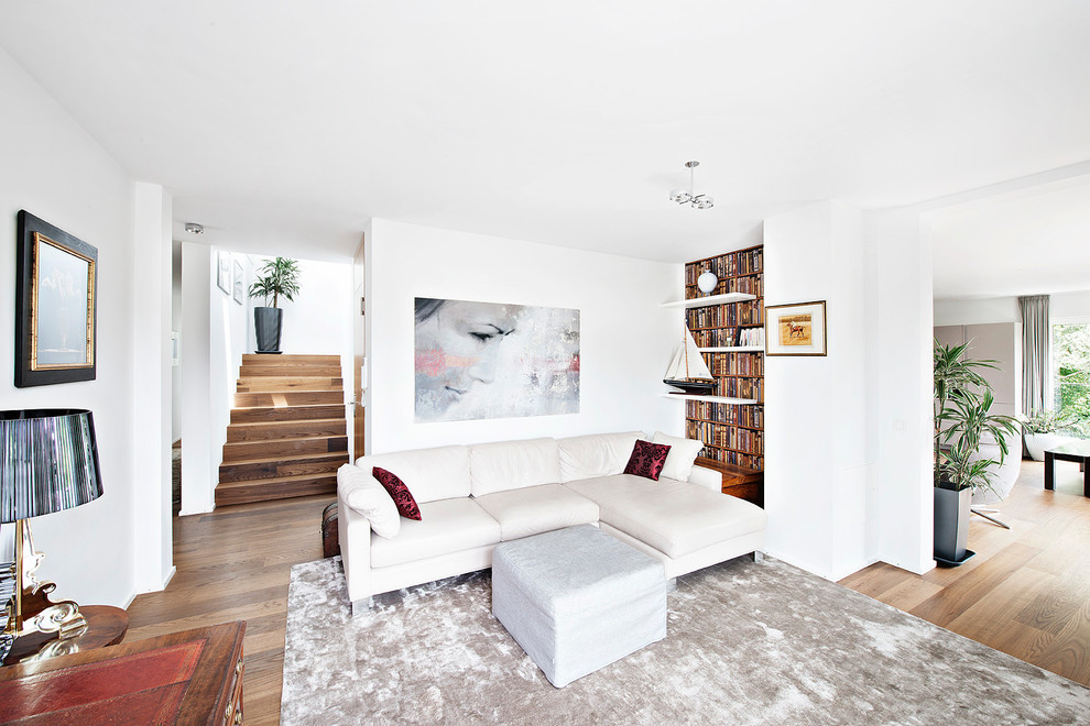 Photo of a large contemporary formal open concept living room in Munich with white walls and dark hardwood floors.