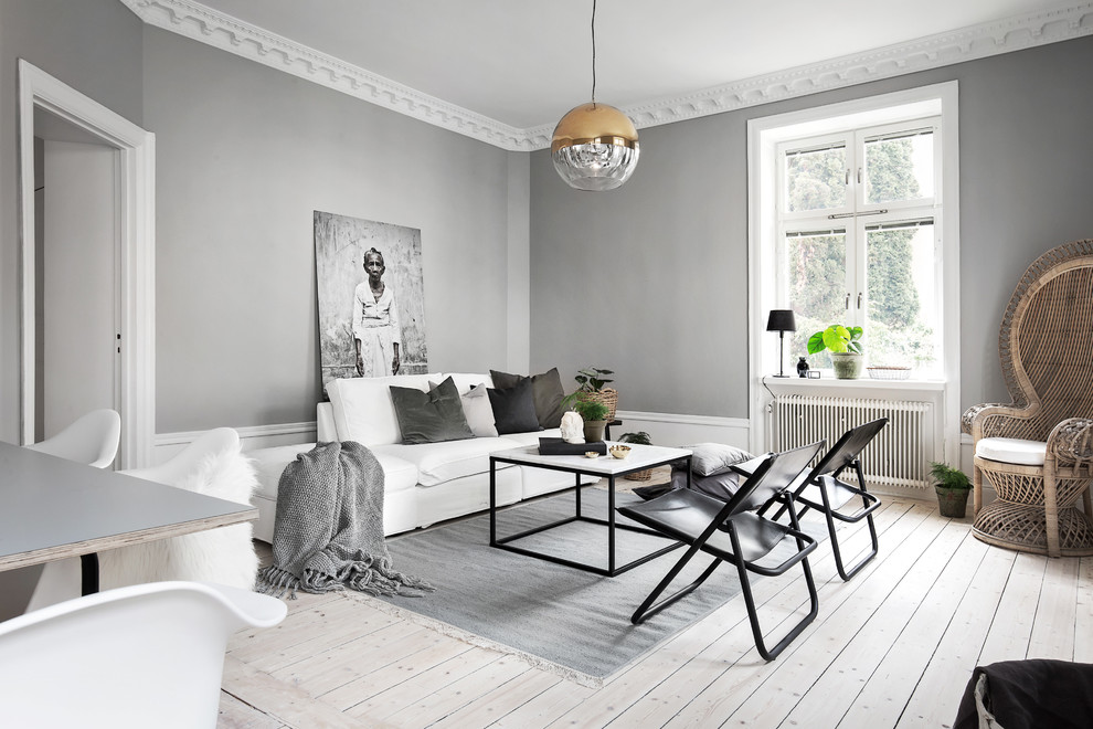 Mid-sized scandinavian formal open concept living room in Stockholm with grey walls, light hardwood floors and no tv.