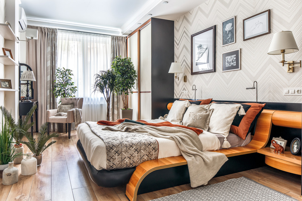 Photo of a mid-sized transitional master bedroom in Other with beige walls, laminate floors and beige floor.