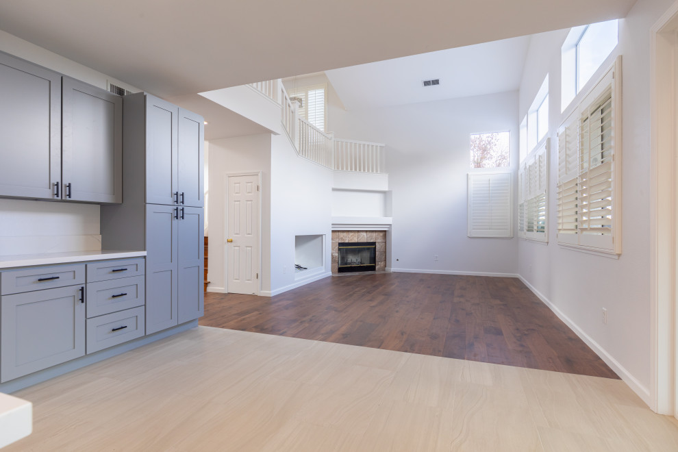 Inspiration för mellanstora moderna separata vardagsrum, med brunt golv, ett finrum, vita väggar, mellanmörkt trägolv, en öppen hörnspis och en spiselkrans i trä
