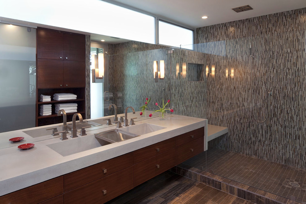 This is an example of a large contemporary master bathroom in Austin with mosaic tile, flat-panel cabinets, medium wood cabinets, an alcove shower, black tile, brown tile, gray tile, multi-coloured walls, porcelain floors, a trough sink and engineered quartz benchtops.