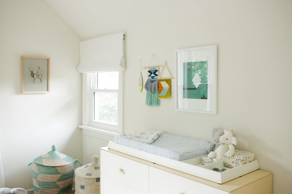 Design ideas for a mid-sized midcentury gender-neutral nursery in Nashville with white walls, medium hardwood floors and brown floor.