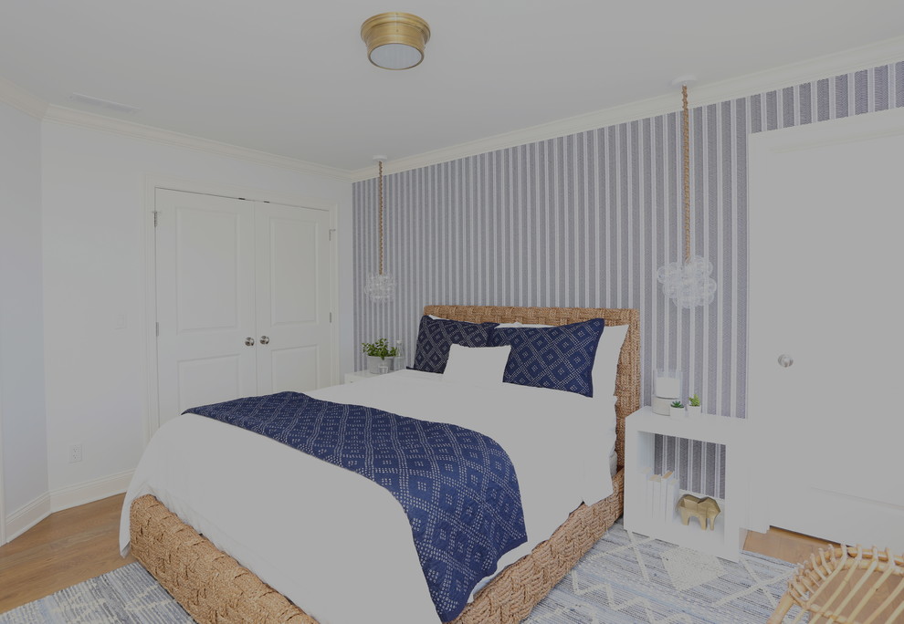 This is an example of a mid-sized transitional guest bedroom in New York with blue walls, light hardwood floors, no fireplace and beige floor.