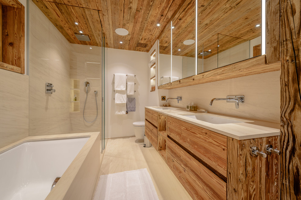 Photo of a country master bathroom in Other with flat-panel cabinets, medium wood cabinets, an undermount tub, a curbless shower, beige tile, white walls, an undermount sink, beige floor, a sliding shower screen and beige benchtops.