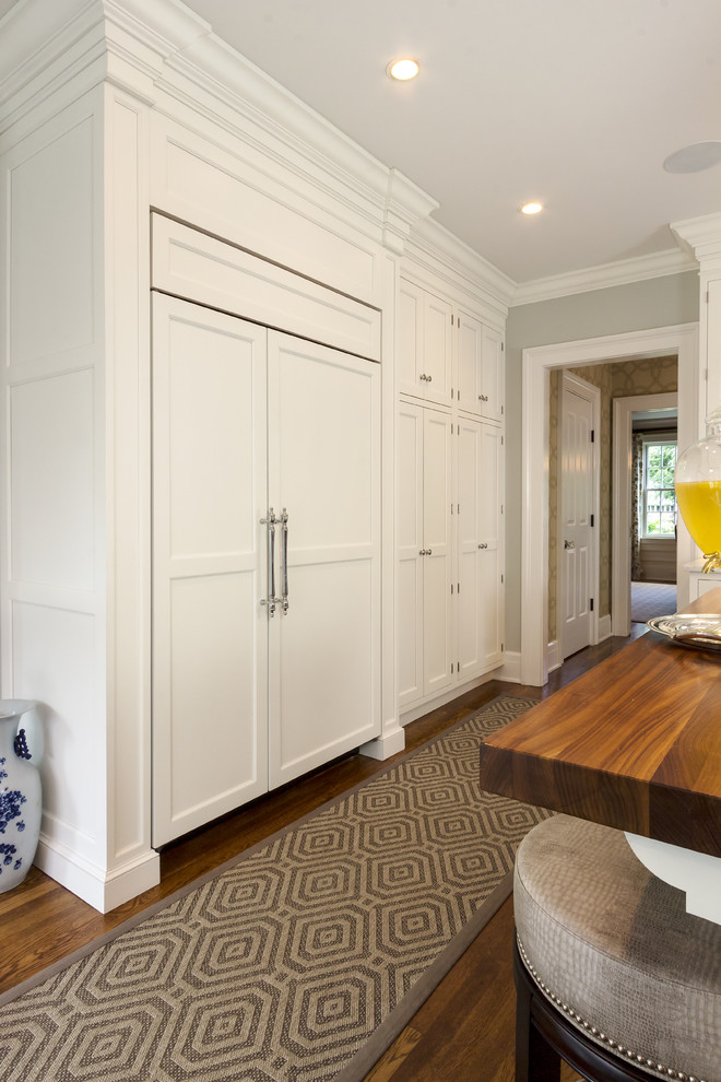 Example of a transitional kitchen design in New York with two islands