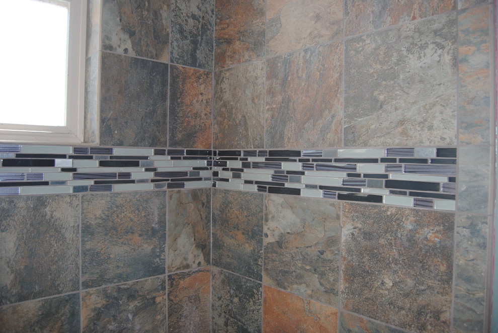 Tub/shower combo - rustic multicolored tile and porcelain tile tub/shower combo idea in Denver