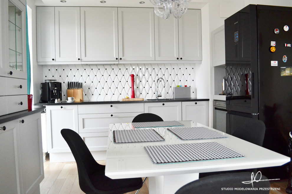 Small eclectic l-shaped light wood floor open concept kitchen photo with a drop-in sink, wood countertops, white backsplash, ceramic backsplash and no island