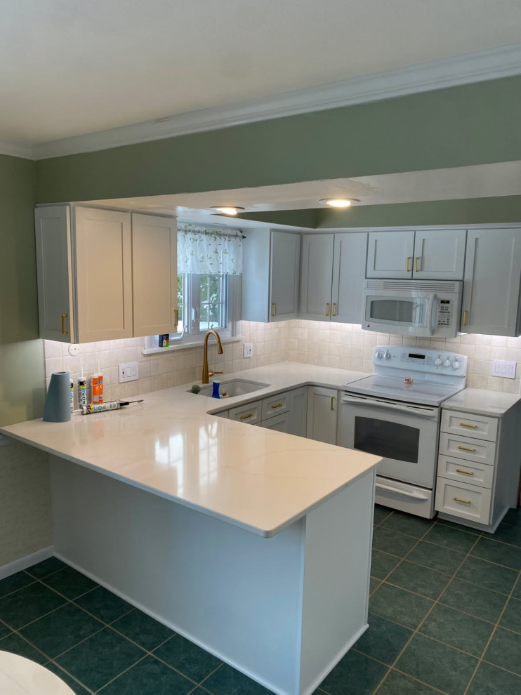Mid-sized transitional u-shaped enclosed kitchen photo with shaker cabinets, white cabinets and quartz countertops