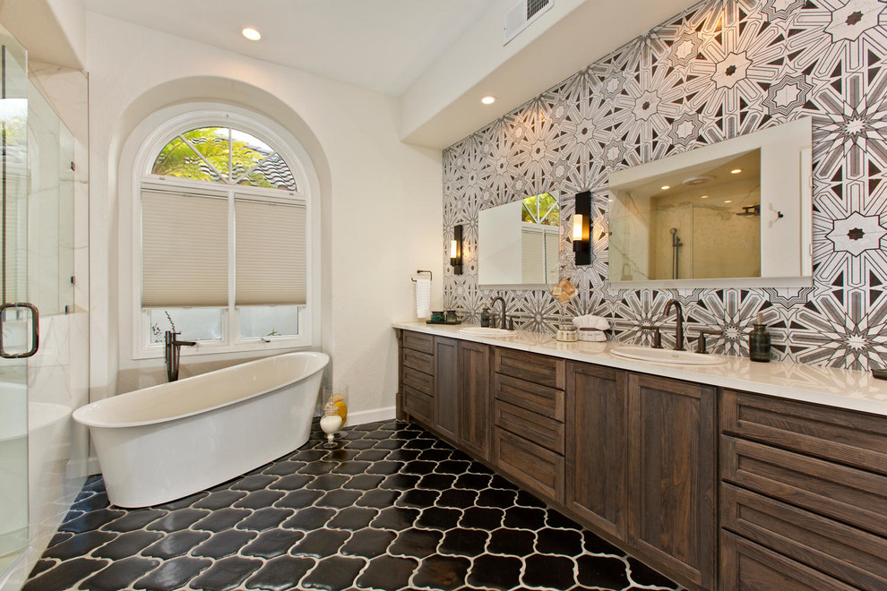 Inspiration for a large transitional master bathroom in Denver with recessed-panel cabinets, a freestanding tub, an alcove shower, a wall-mount toilet, gray tile, terra-cotta tile, white walls, terra-cotta floors, an undermount sink, engineered quartz benchtops and dark wood cabinets.