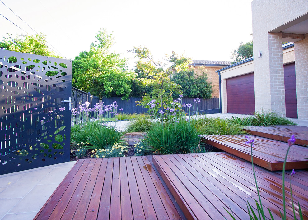 Inspiration for a large modern front yard full sun xeriscape in Melbourne with decking.