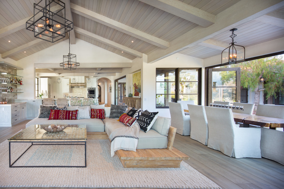 Large contemporary open concept living room in Santa Barbara with beige walls, light hardwood floors and beige floor.