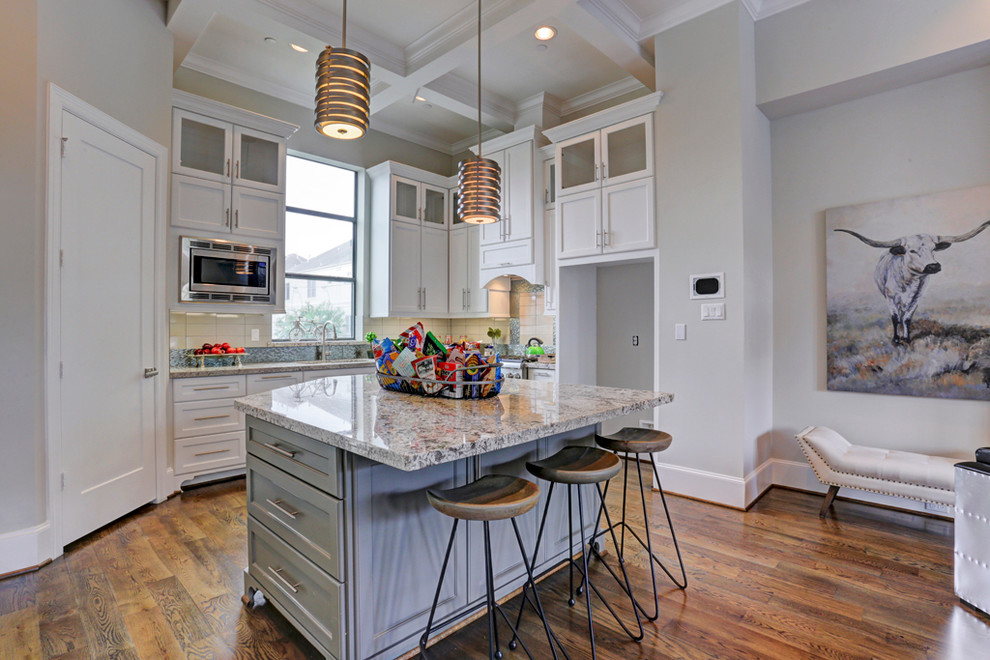 This is an example of a large transitional u-shaped kitchen pantry in Houston with an undermount sink, louvered cabinets, white cabinets, laminate benchtops, white splashback, ceramic splashback, stainless steel appliances, dark hardwood floors and multiple islands.